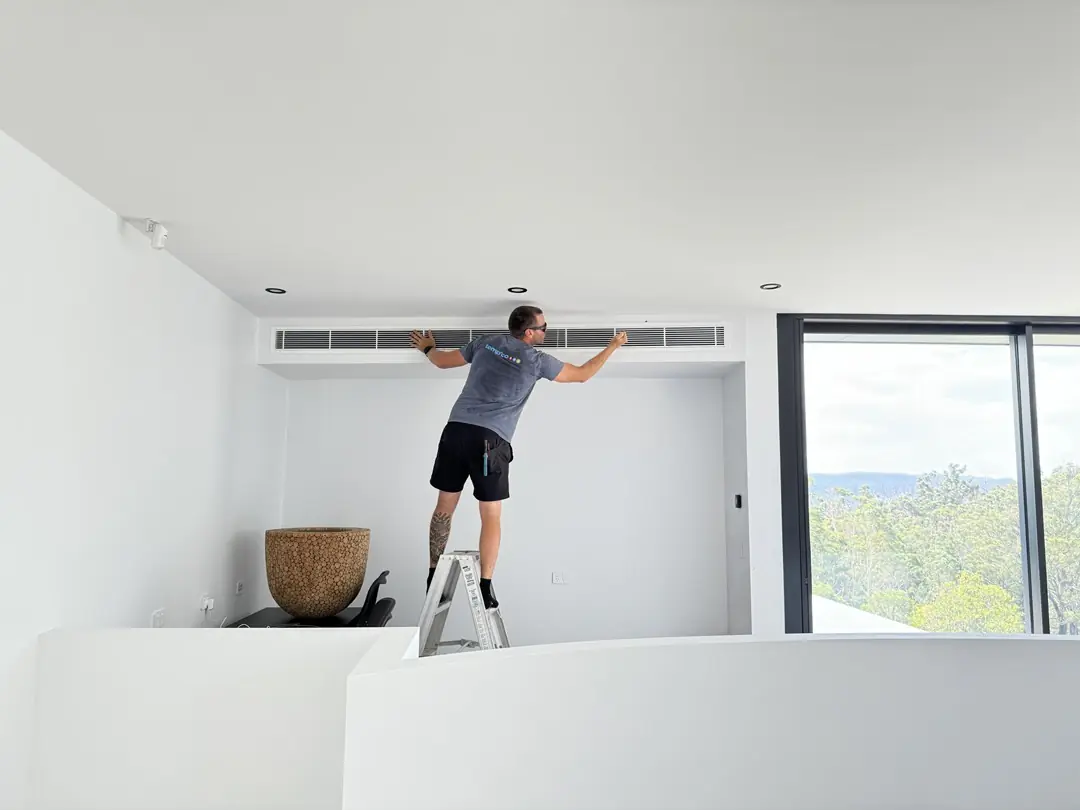 TempcoFRH technician fitting a linear grille for a ducted air conditioning system